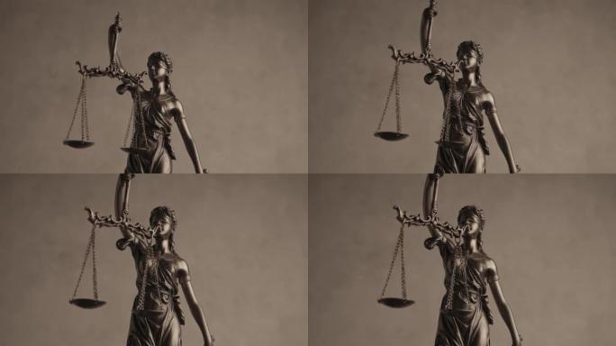 正义是被蒙住眼睛的青铜法律雕像，剑和平衡在棕色背景前旋转，说明权力和权利的概念