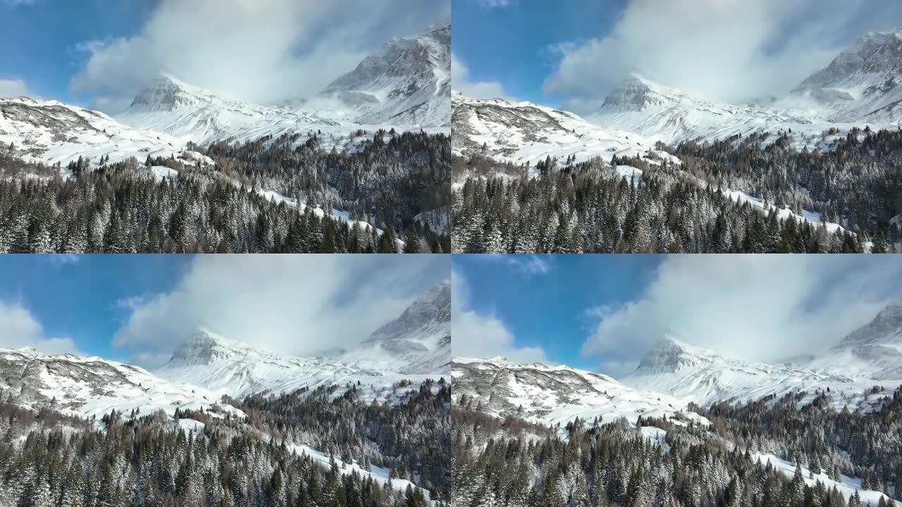 飞越白雪覆盖的森林，在白雪覆盖的高山山脉下