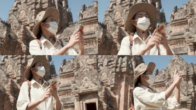 亚洲妇女在疫情期间独自旅行。戴防护口罩保护自己。