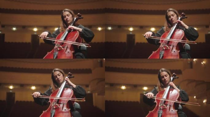 孤独的女人在音乐厅演奏大提琴，美丽的女大提琴家在现场排练