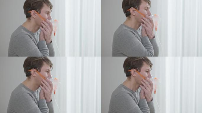 使用吸入器吸入和呼气的集中黑发高加索人的侧视图。使用雾化器治疗呼吸系统疾病的男性患者。保健和医学概念
