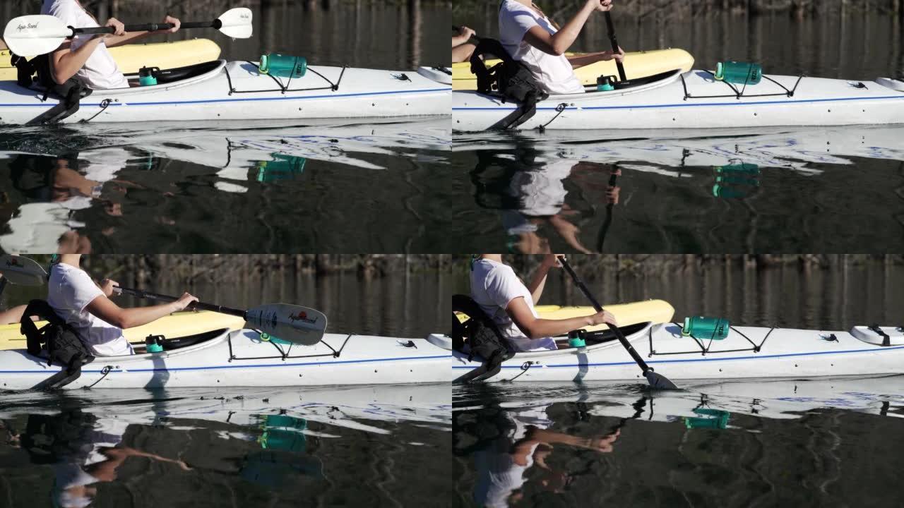 一名女性皮划艇运动员在河里划桨的细节照片