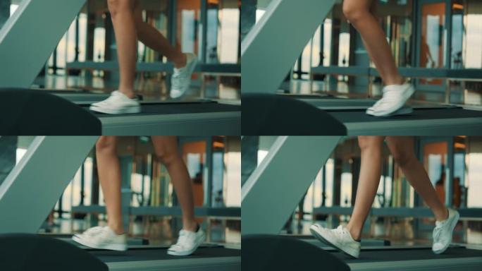 亚洲妇女在健身房的跑步机上锻炼