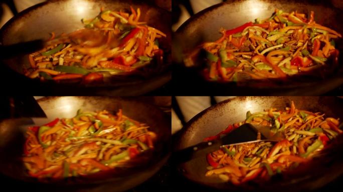 在室外炉灶上烹饪蔬菜和辣椒的详细照片