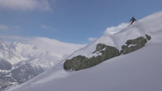 慢动作拍摄的滑雪者经过摄像机，后面有山