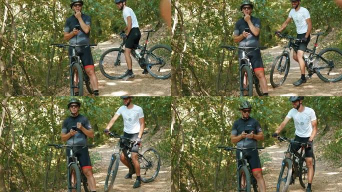 活跃活跃的游客带着他们的山地自行车正在智能手机上查看培训数据