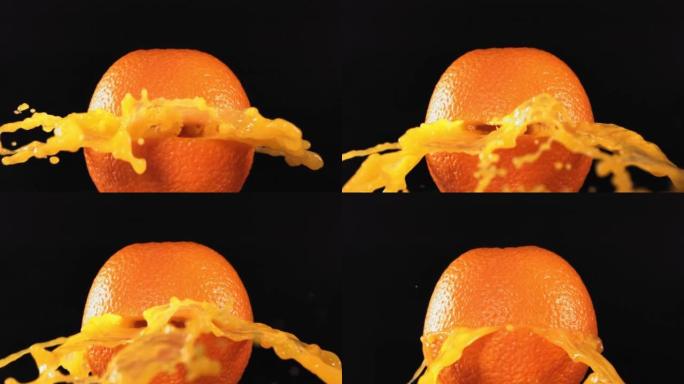 黑色背景4K慢动作的新鲜橙色水果喷出并爆裂果汁