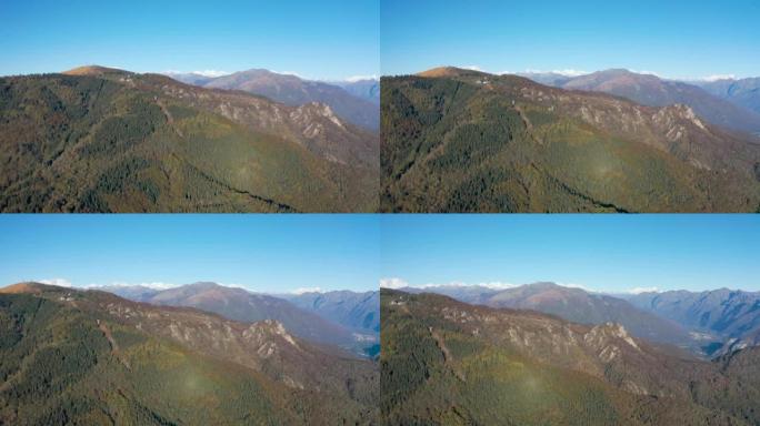 在高大的山峰和山谷之间飞行的鸟瞰图，湖泊