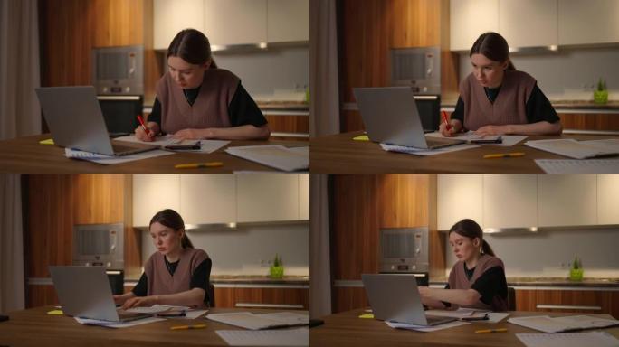 商业经济学家分析师说，一个女人在家庭办公室里用笔记本电脑远程工作的肖像，并在图表上记录数据
