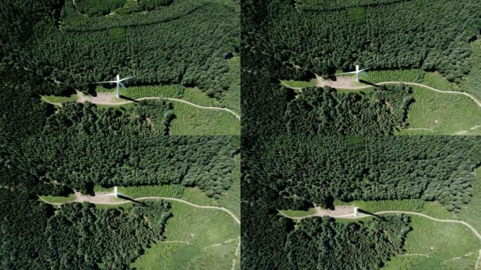 空中无人机在森林附近拍摄风车