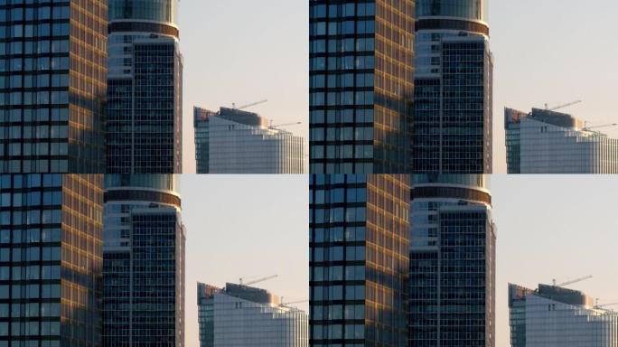 日落时建筑中的现代摩天大楼的航拍