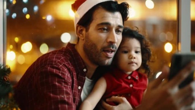 快乐的爸爸和一个可爱的女孩，享受与家人交谈的视频通话，并在家中圣诞快乐。
