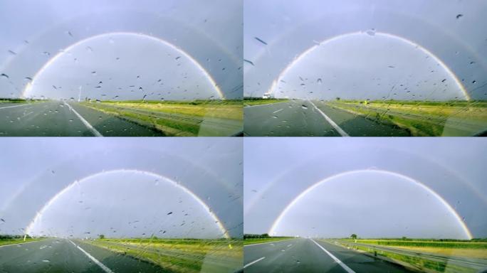 POV汽车驾驶。在雨中追逐彩虹
