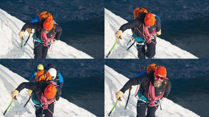 一队登山者在山顶上移动。冬季冒险