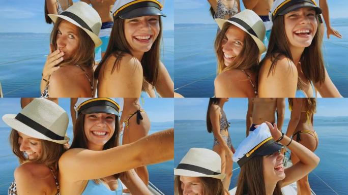两名年轻女子在游艇上与朋友玩耍时对着镜头微笑