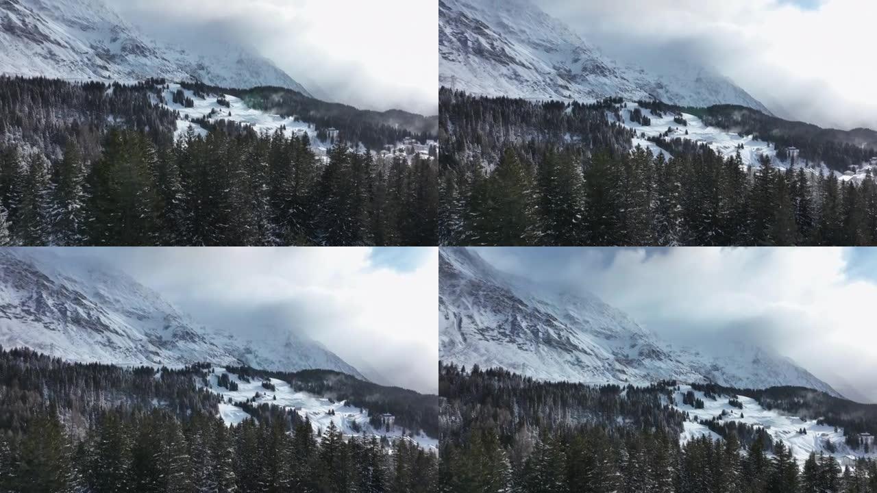 飞越白雪覆盖的森林，在白雪覆盖的高山山脉下