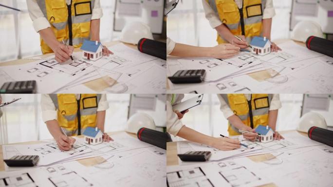 hands工程师和建筑师团队的特写镜头讨论了办公室内的设计施工和建筑图纸工作。