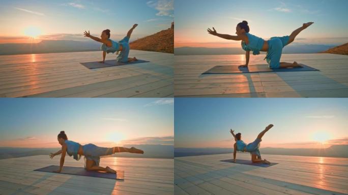 CS女子在日落时在山顶上摆瑜伽姿势