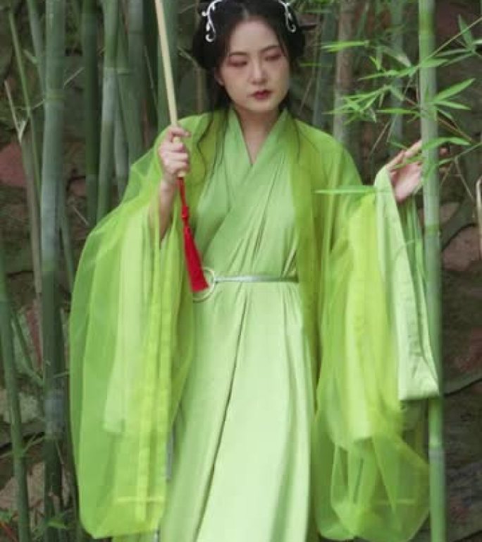 汉服美女在竹林里拿着油纸伞