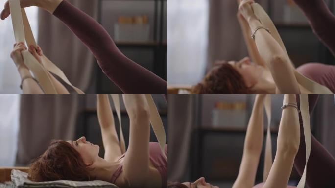 体操为了健康，女人独自在家训练，用弹性胶带做运动，移动脚的细节