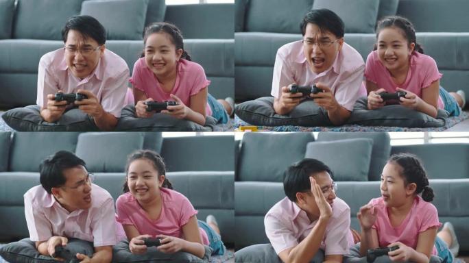女孩和她的父亲用游戏手柄玩控制台电脑游戏，在家玩得开心