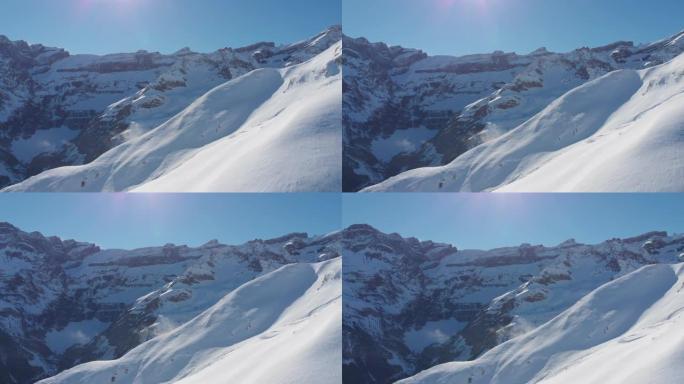 在晴朗的日子里，空中无人机拍摄了白雪皑皑的山坡