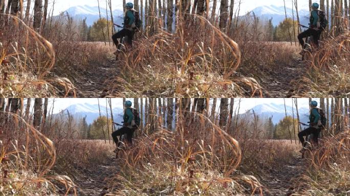 女山地车手沿着高山小径，远处的山脉