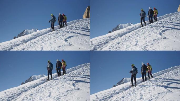 一队登山者沿着陡峭的山峰移动。使用绳索和攀爬设备