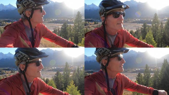 山地车手将自行车推向高山小径，遥远的山脉