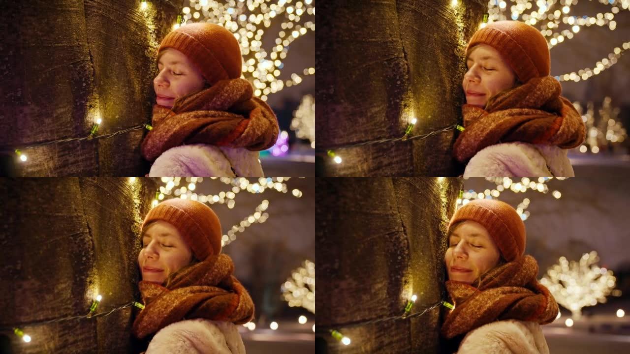 女人在下雪的夜晚以慢动作拥抱圣诞树