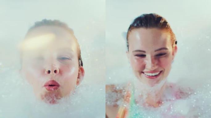 快乐美丽的女人快乐而轻松地覆盖着沐浴泡沫。慢动作，垂直拍摄。