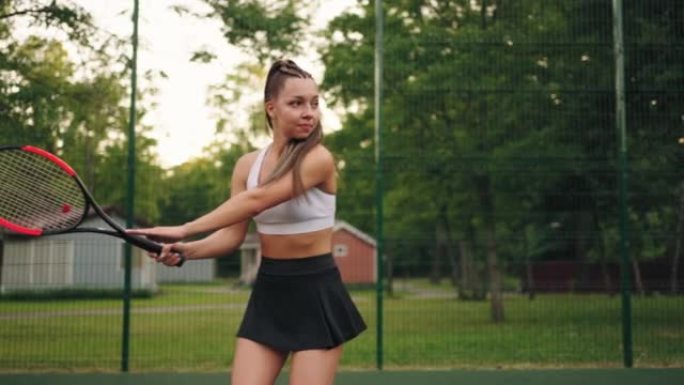 性感的女士正在打网球，夏天在公开球场上训练，练习球拍击球，慢动作
