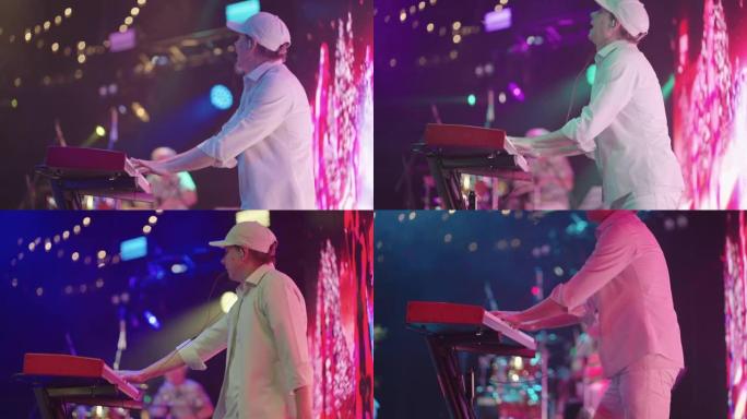 键盘手正在通过合成器播放音乐，并在舞台上的演出中跳舞，充满活力和活跃