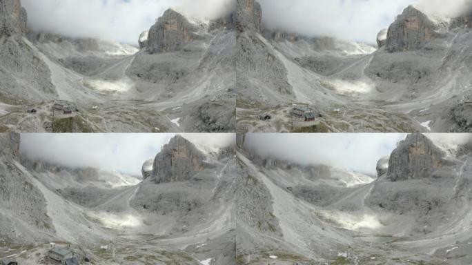 在高耸的山峰和山谷之间飞行的鸟瞰图