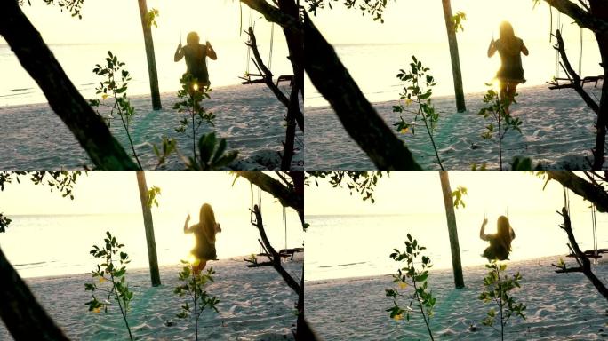 日落时，年轻女子在海滩上荡秋千