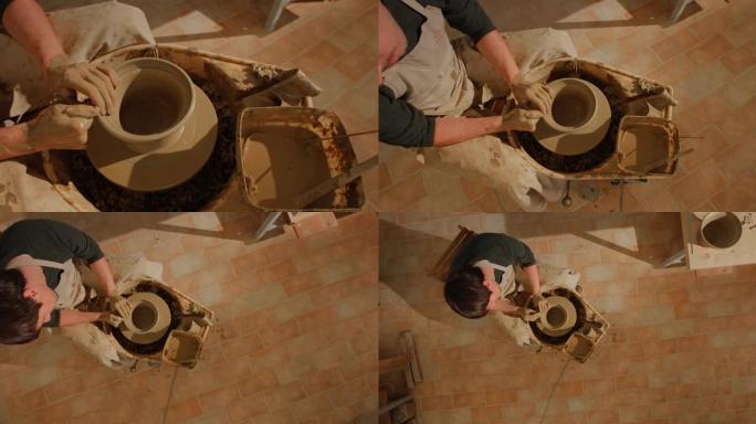 CS男性陶工在旋转的陶工轮子上创造一个碗