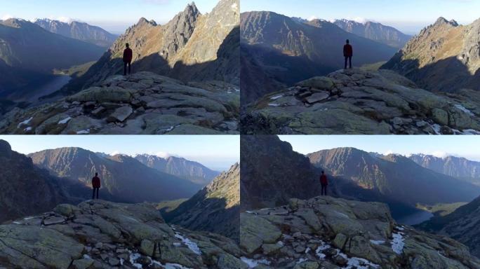 在世界之巅。登山者从山顶欣赏风景。无人机视图