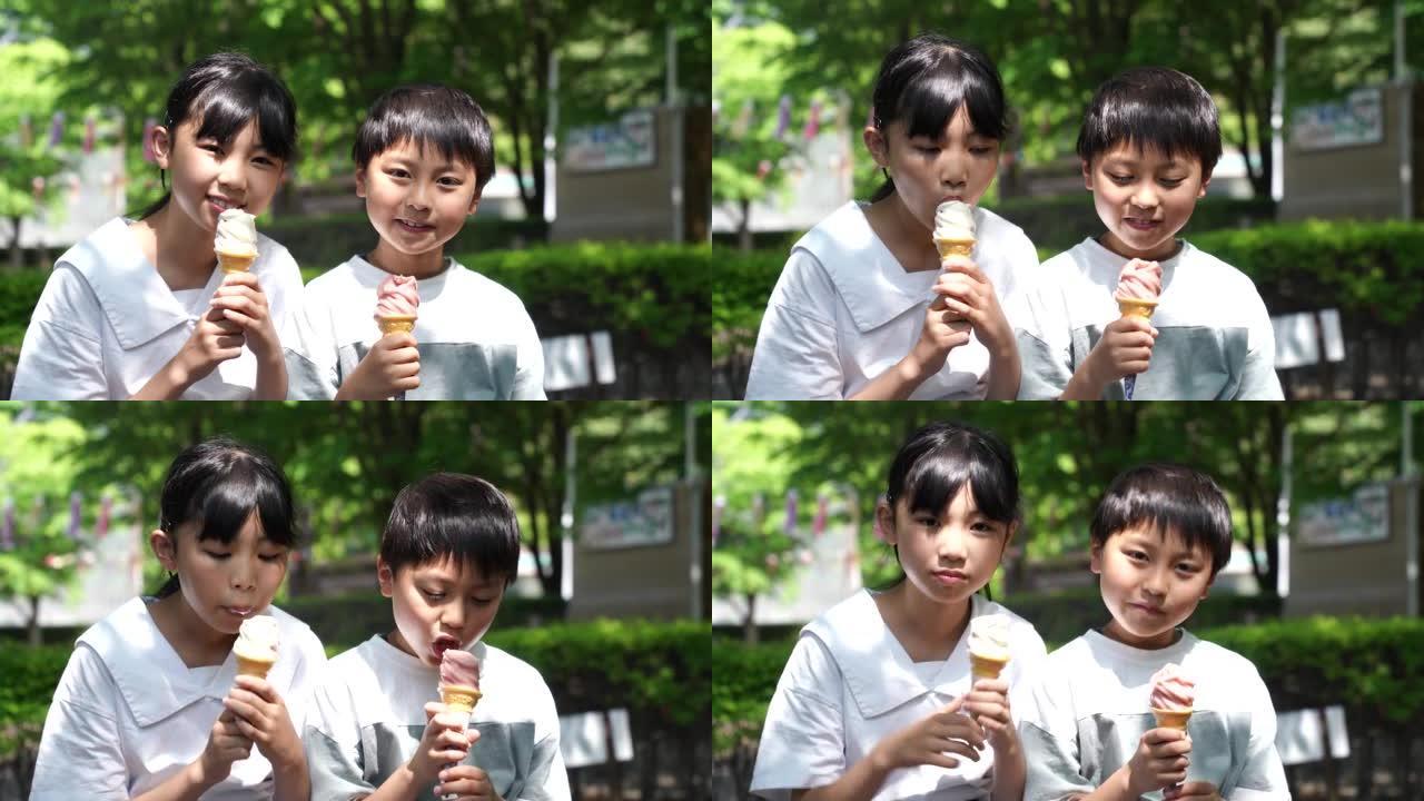 亚洲孩子在新鲜的绿色公园吃软冰淇淋