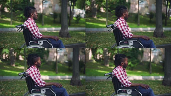 非裔美国残疾人坐在轮椅上，感到孤独