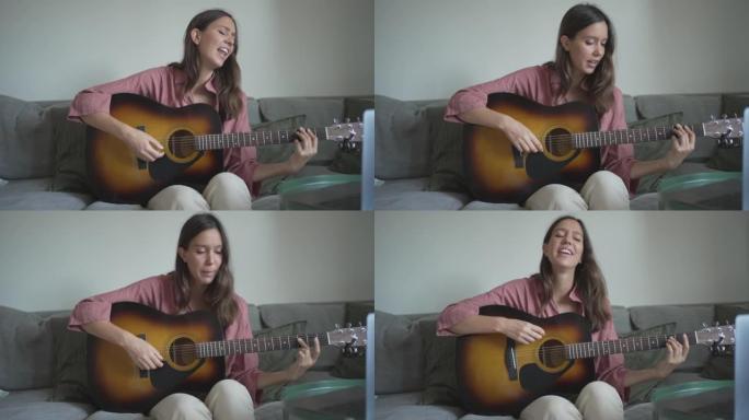 年轻女子在客厅里弹吉他