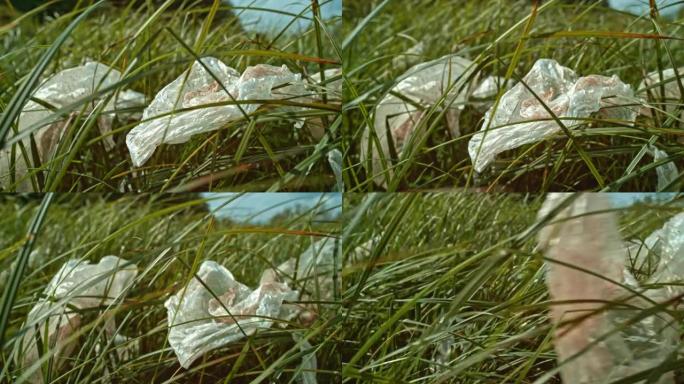 SLO MO脏塑料袋在高高的草丛中随风移动