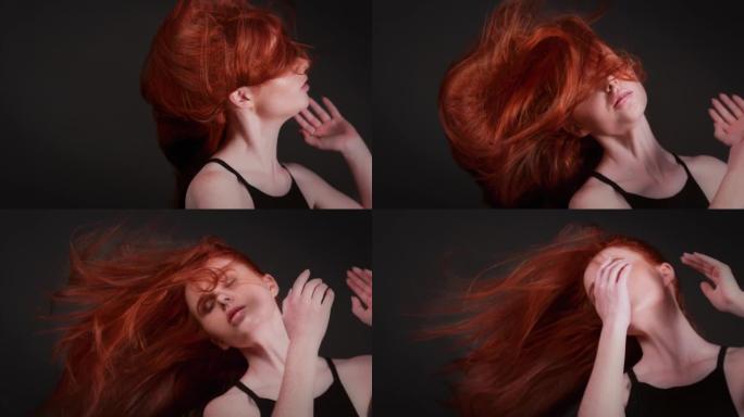 美丽的红发女人，留着长长的直发，闭着眼睛。诱人的舞蹈