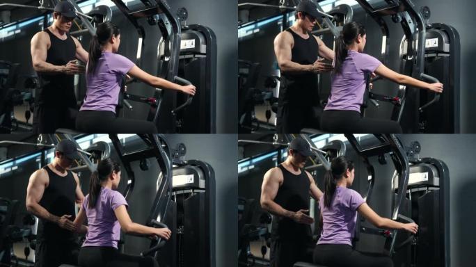 亚洲男老师教健身年轻女性开始使用健身房。