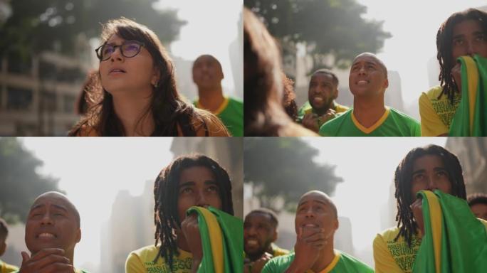 Brazilian friends watching a soccer game outdoors