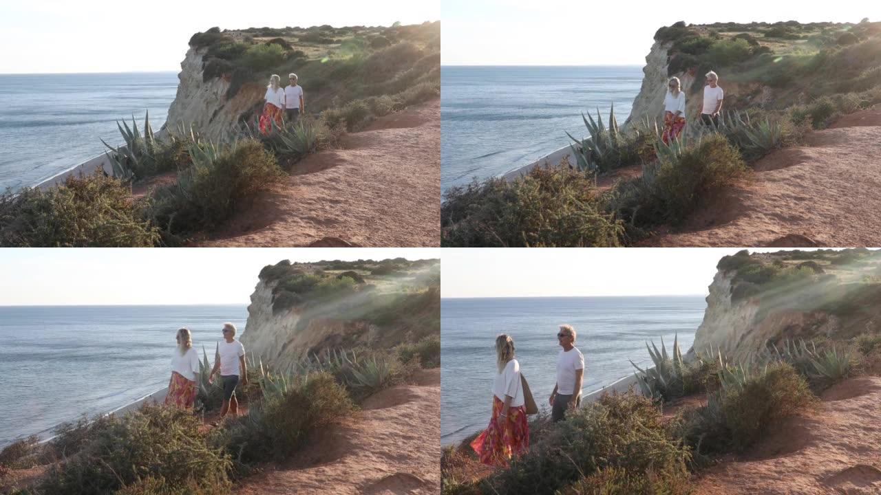 夫妇沿着悬崖悬崖，在遥远的海面上行走