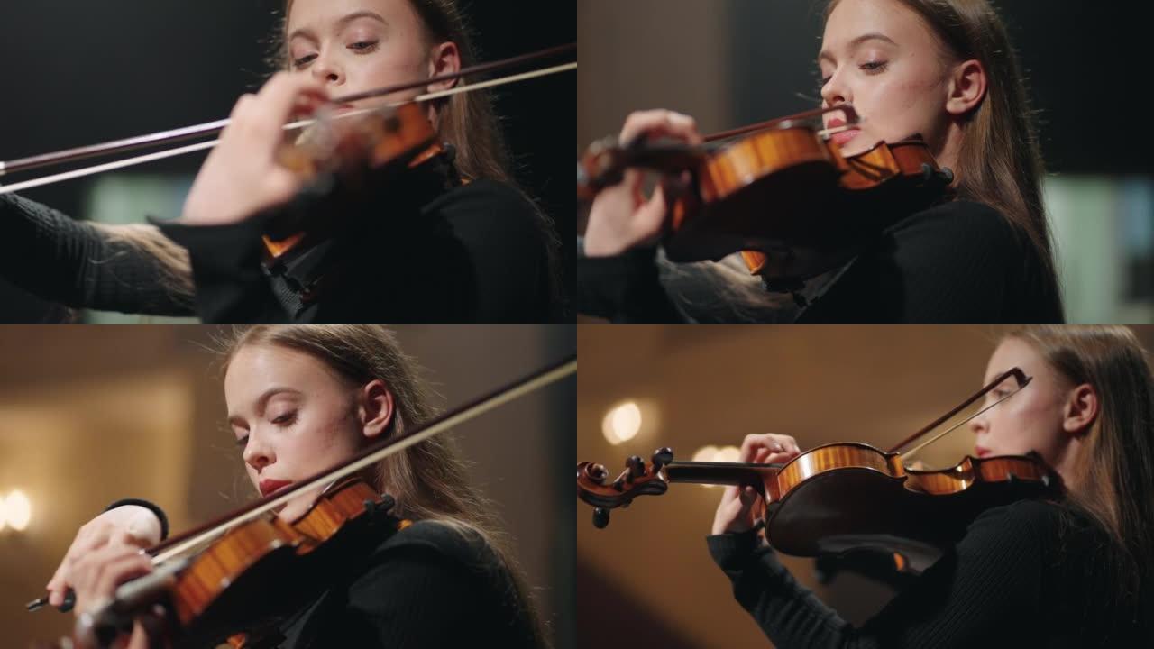 交响乐团中的女提琴手在歌剧院现场，女士正在拉小提琴或中提琴