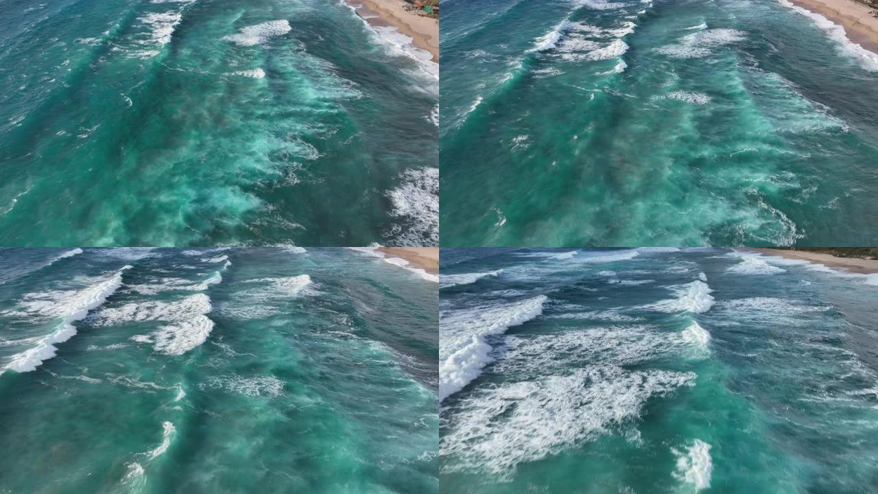 海浪滚入沙滩的鸟瞰图，低角度靠近水面移动