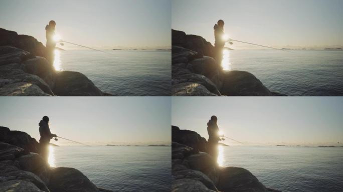 挪威的户外活动: 女人用鱼竿在海里钓鱼