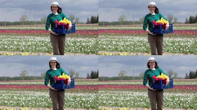 肖像快乐女农夫拿着篮子盒子新鲜采摘郁金香花卉农场