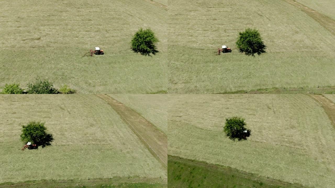 空中无人机在田野上的拖拉机上拍摄了一名农民